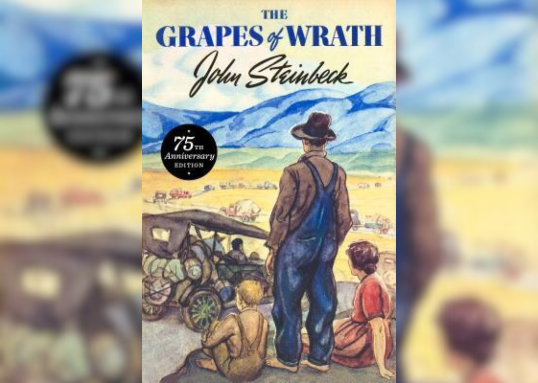 A painting of a family watching an endless road of old cars driving across the foothills.