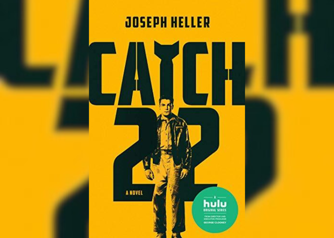 A man standing in front of a yellow background.