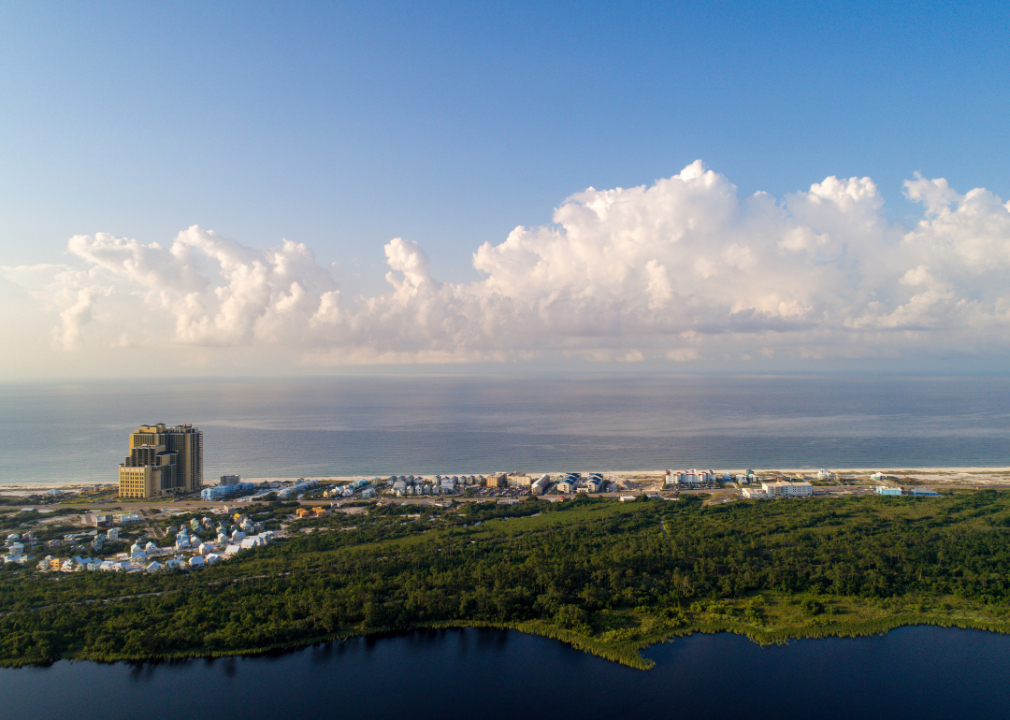Aerial view of Gulf Shores homes and one tall building along the coast.