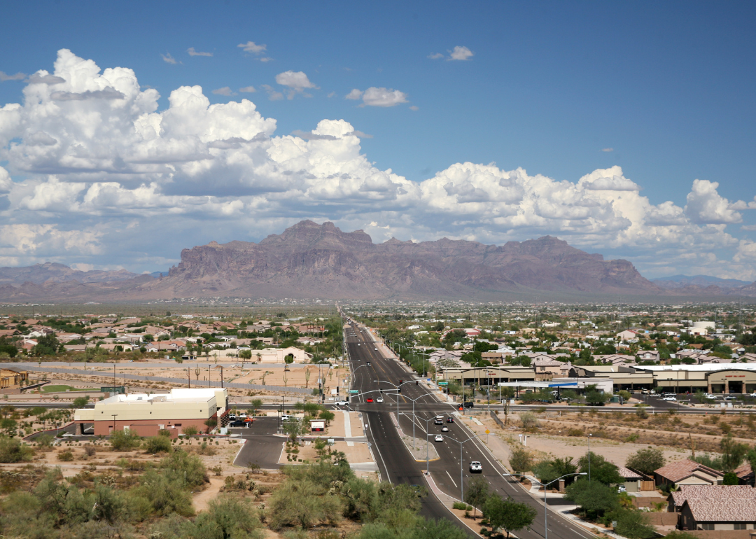 An aerial view of downtown with mountains in the background.