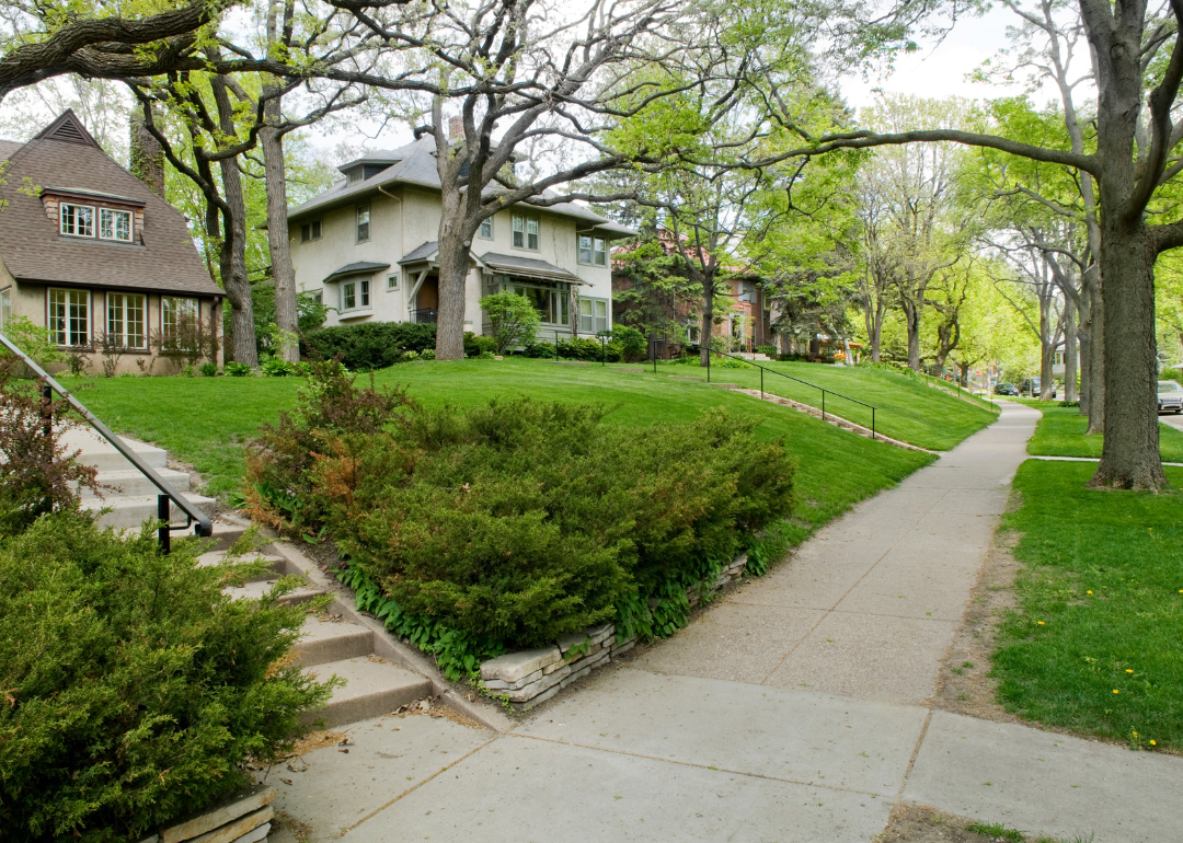 Two story homes on a hill in a residential neighborhood.