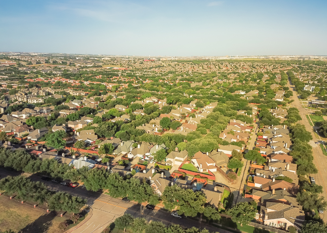 Aerial view of residential homes lined with trees.