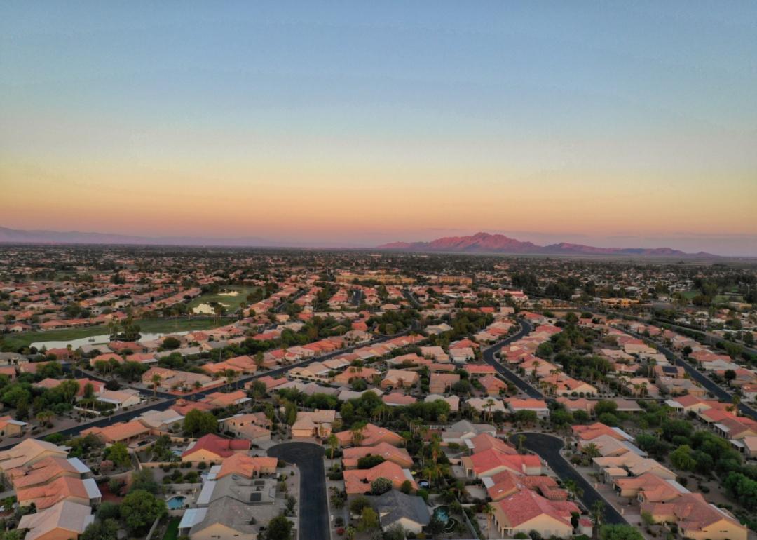 An aerial view of rows of terra cotta colored homes.