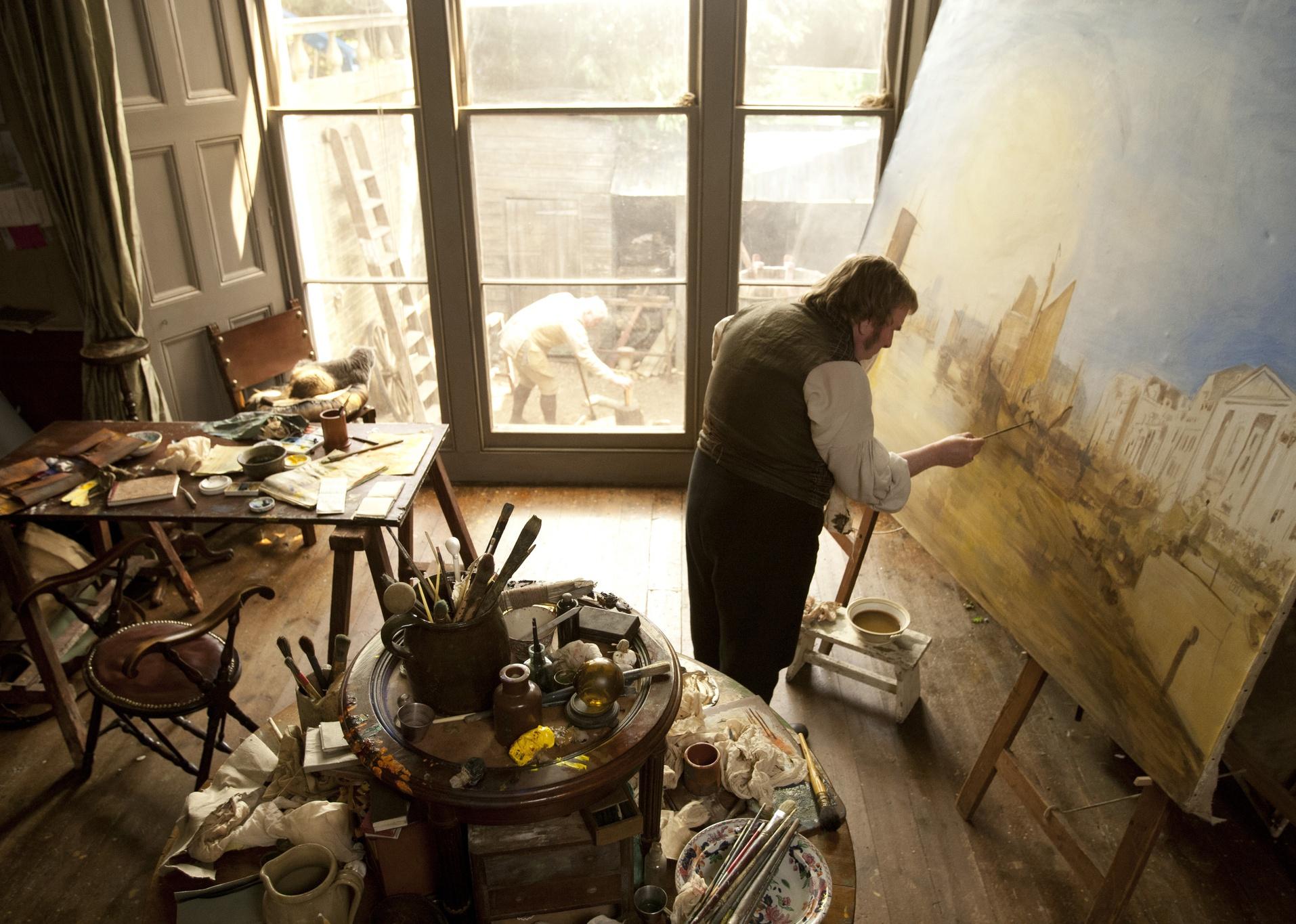 Actor Timothy Spall paints in a scene from ‘Mr. Turner.'