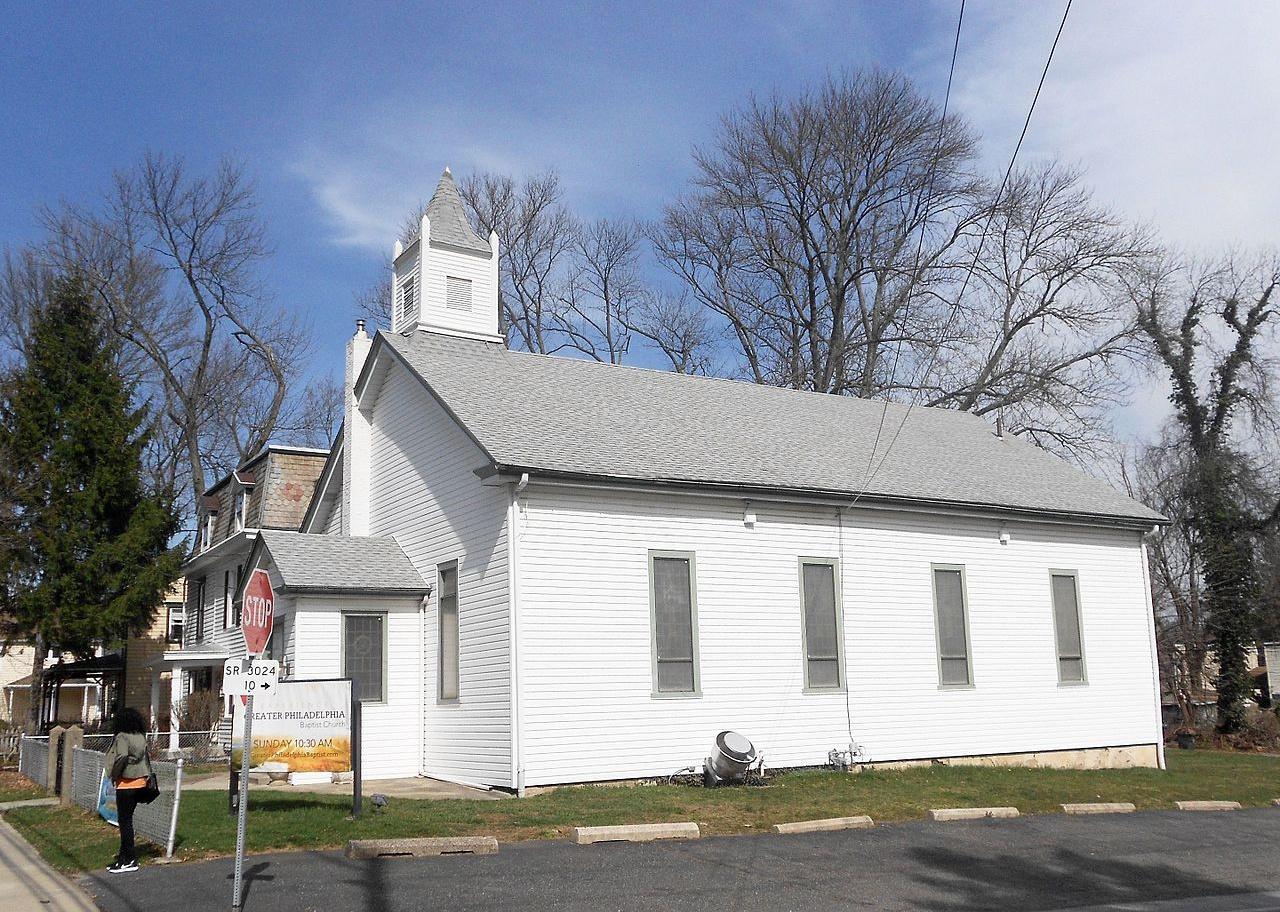 A white church on a small street.