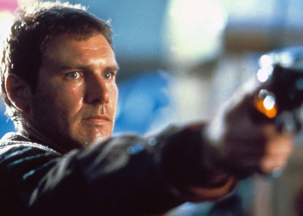 Harrison Ford sweating and pointing a gun.