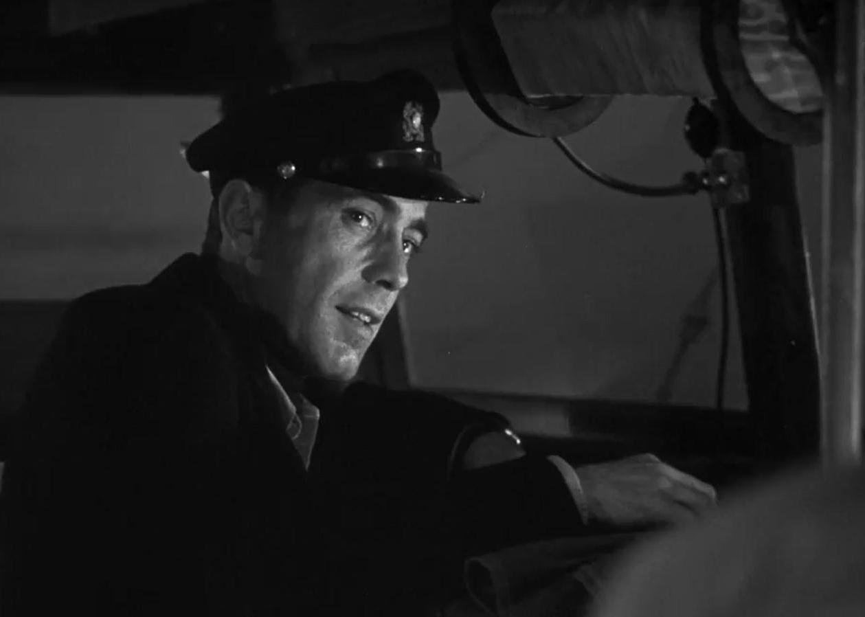 Humphrey Bogart wearing a ship captain's hat.
