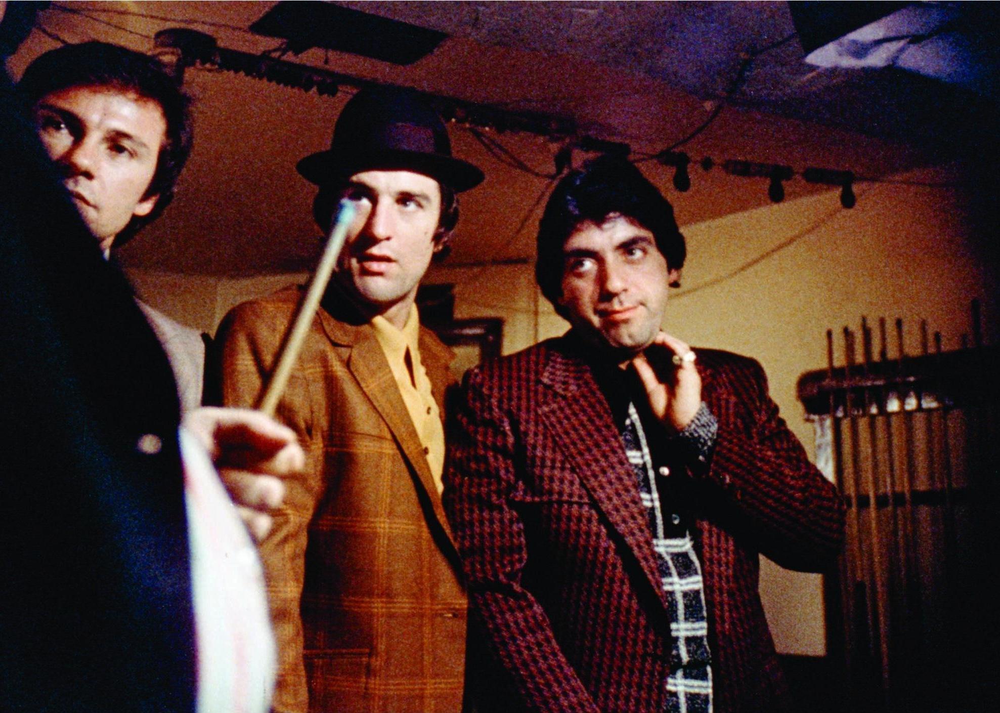 Robert De Niro, Harvey Keitel, and David Proval standing next to a pool table.