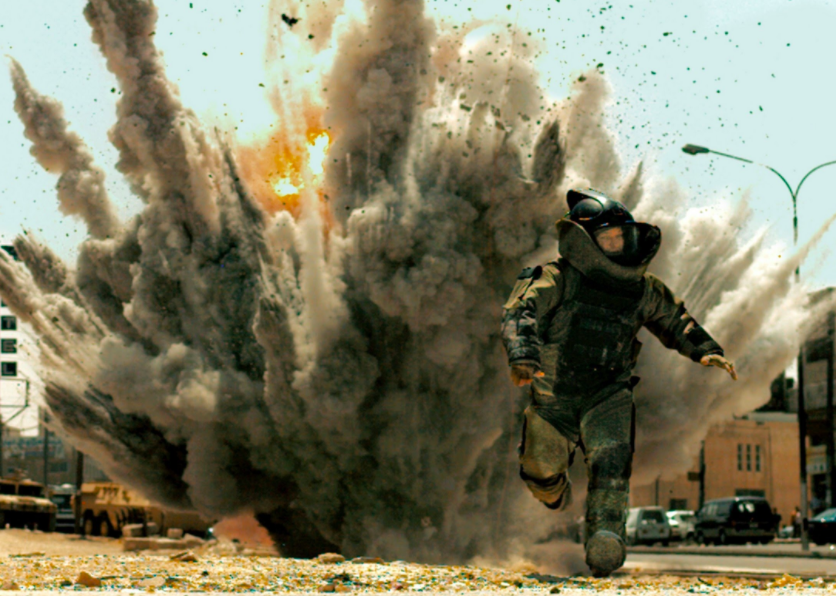 Jeremy Renner in a space-like suit running from an explosion.