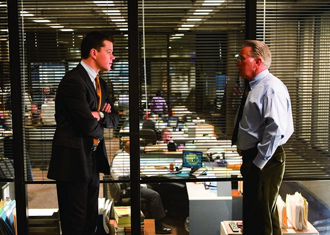 Matt Damon and Martin Sheen talking in an office.