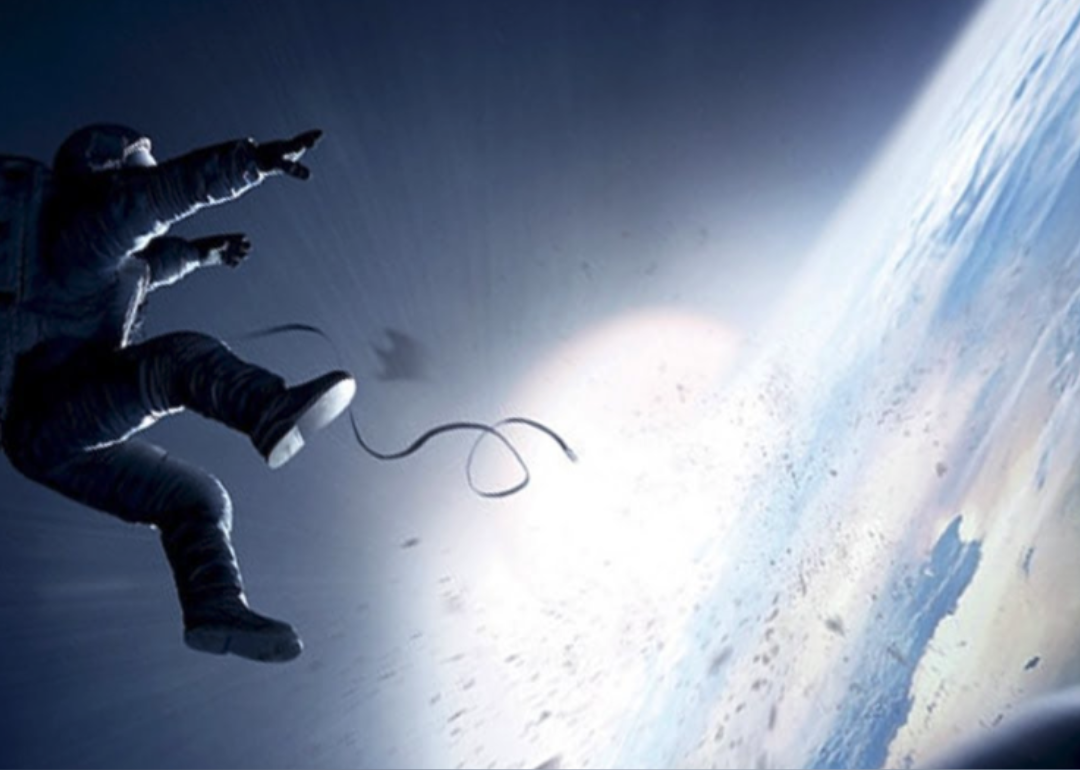 An astronaut floats off into space with some loose debris and a broken cord dangling.