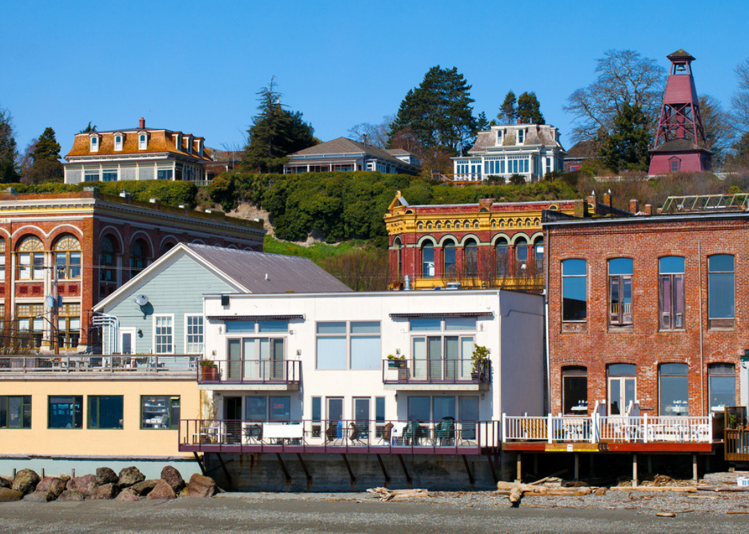 Historic homes and brick buildings with porches on the water.