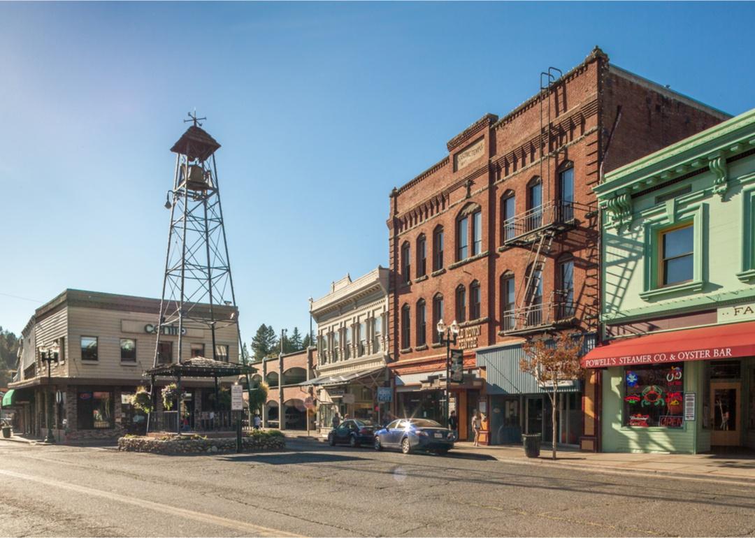 Historic buildings and a bell tower on a small street in town.