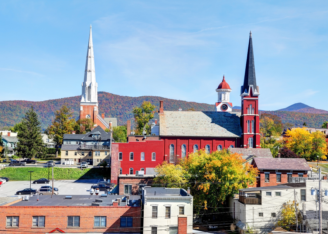 Historic churches with tall steeples in a small town in the hills.