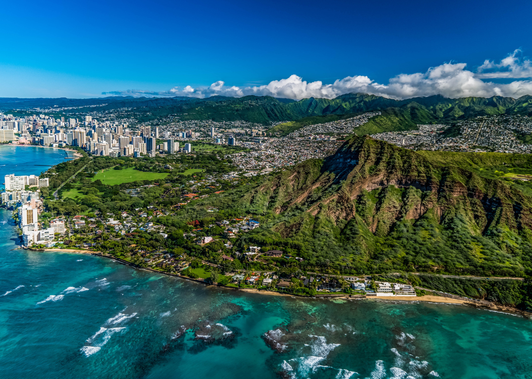 Aerial view of Hawaii beaches, buildings, and mountains.