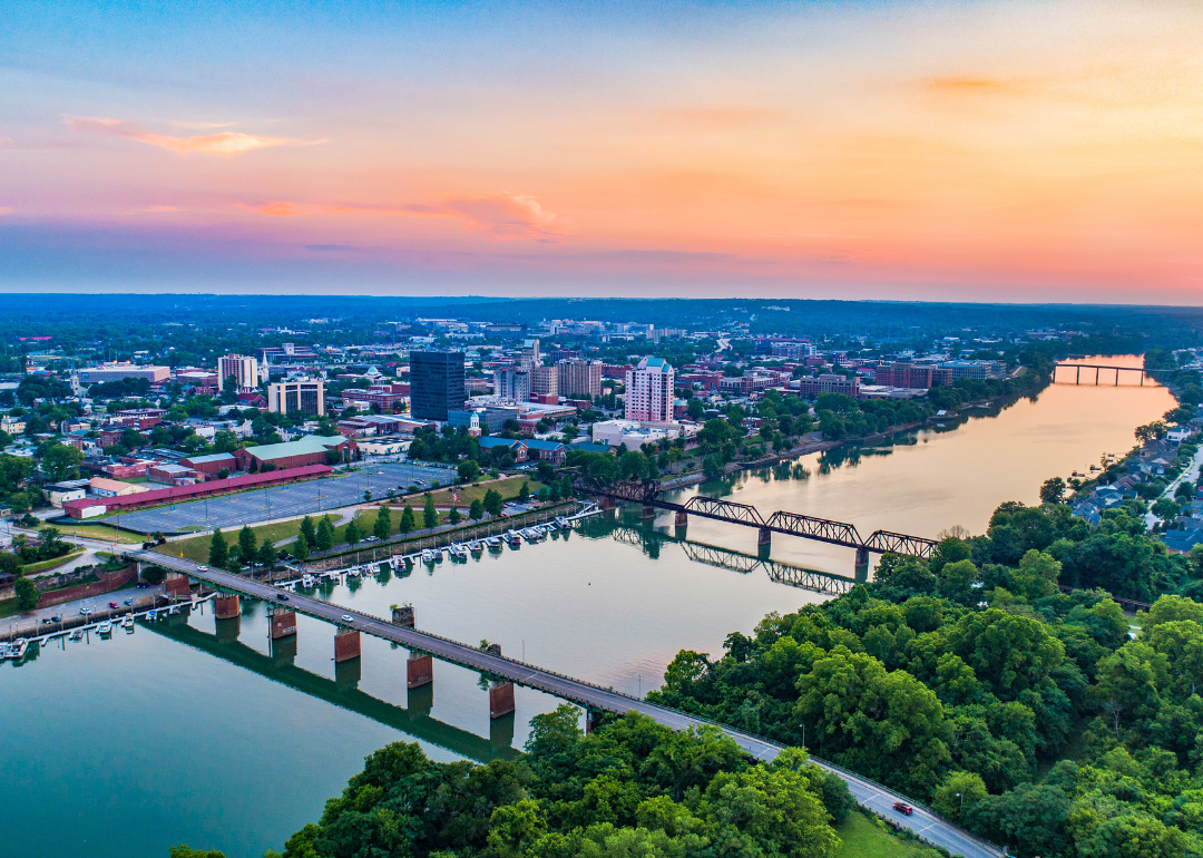 Downtown Augusta, GA with waterway in the front during sunset.