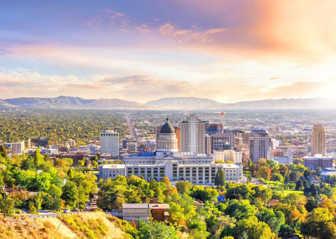 Downtown Salt Lake City, UT surrounded by trees and mountains.