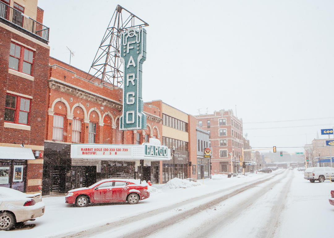 Downtown Fargo, ND historic sign and buildings in the snow.