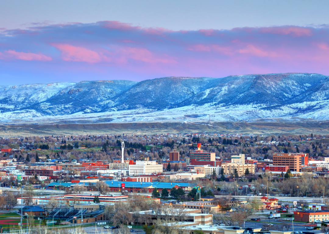 Downtown Casper, WY with mountains and a pink sky in the background.