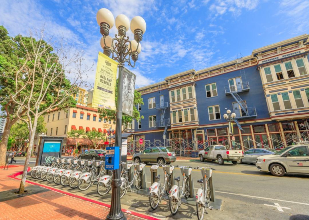 Rentable bicycles by a Gaslamp Quarter sign.