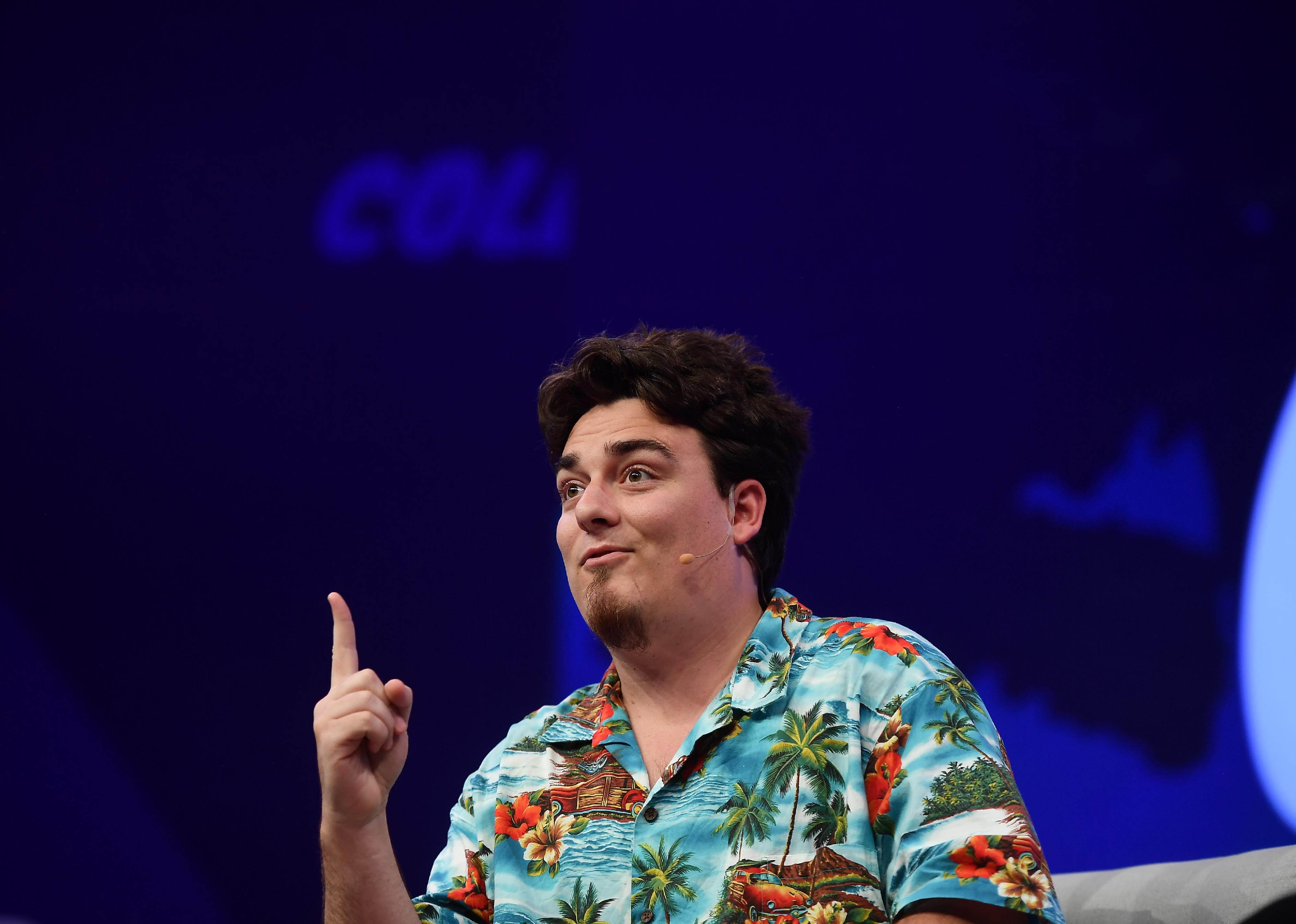 Palmer Luckey in a Hawaiian shirt onstage.