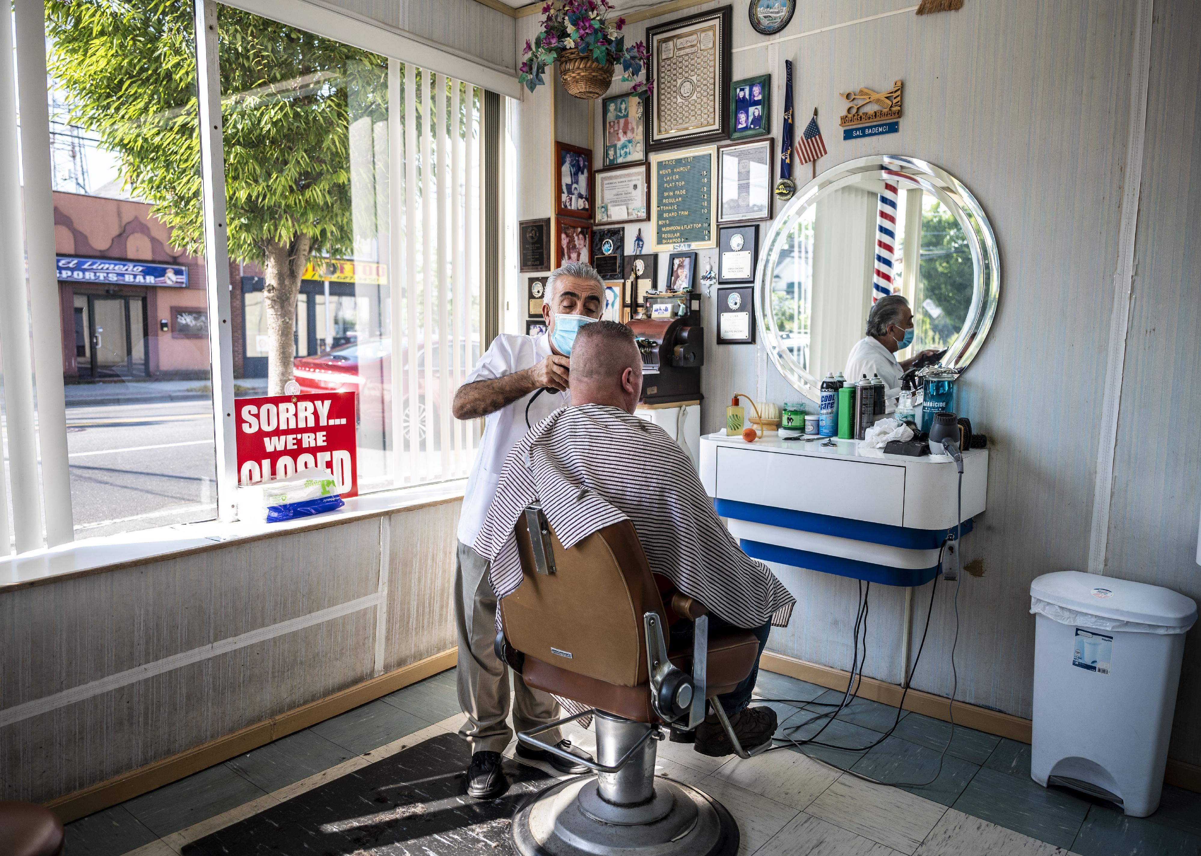 A man cutting hair in a barber shop.