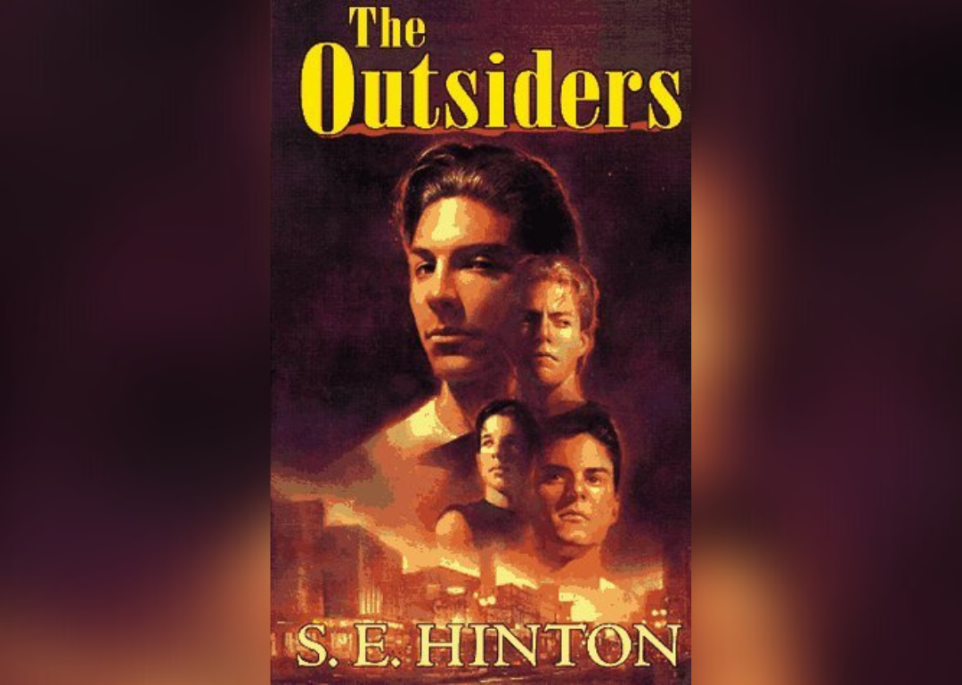 Four male faces over the skyline of a city.