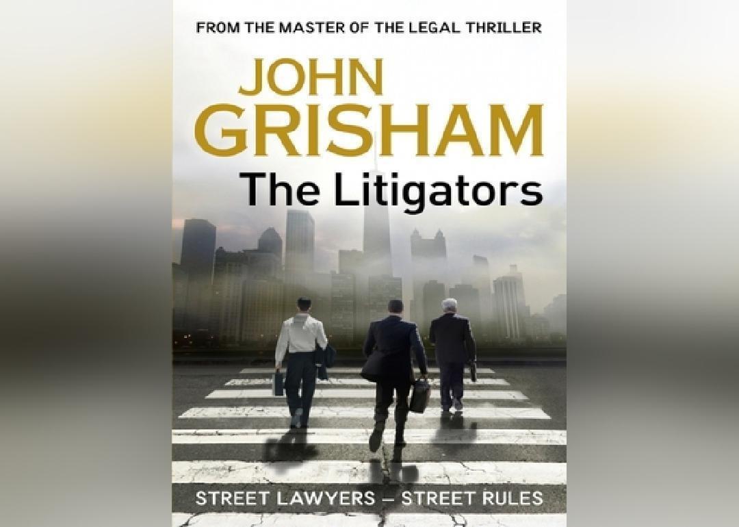 Men in suits on a crosswalk to a city.