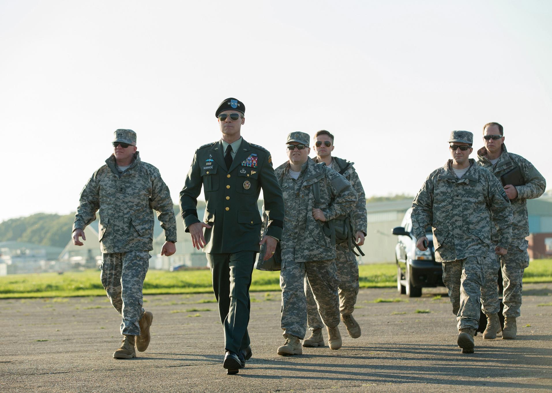 Brad Pitt, in uniform, with Anthony Michael Hall, Daniel Betts, Topher Grace, Anthony Hayes, and John Magaro walking behind him in fatigues. 
