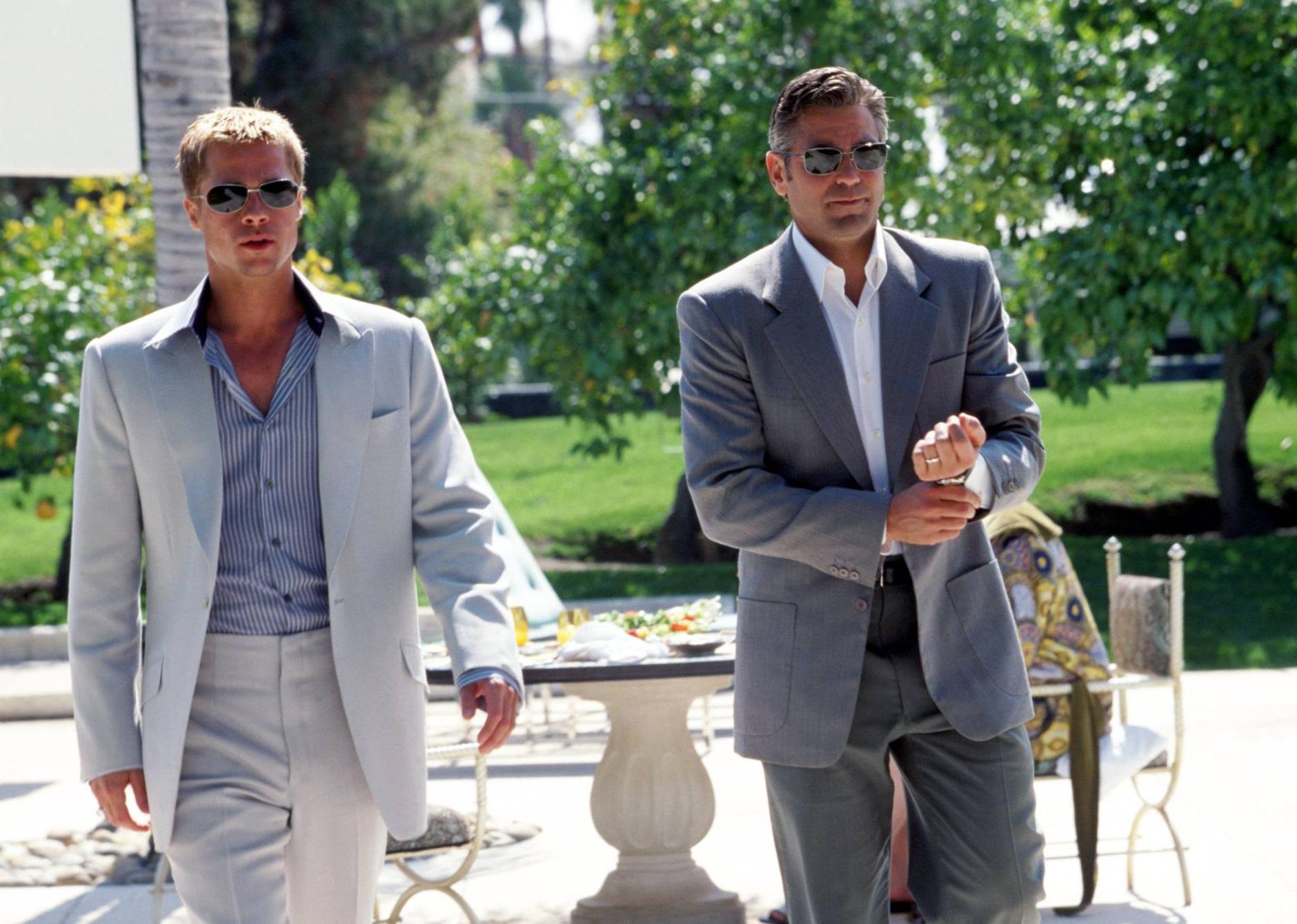 Brad Pitt and George Clooney walking in suits.