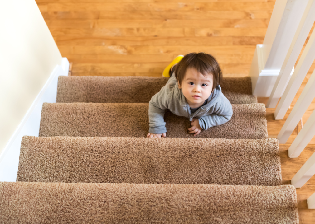 A toddler climbing some stairs.