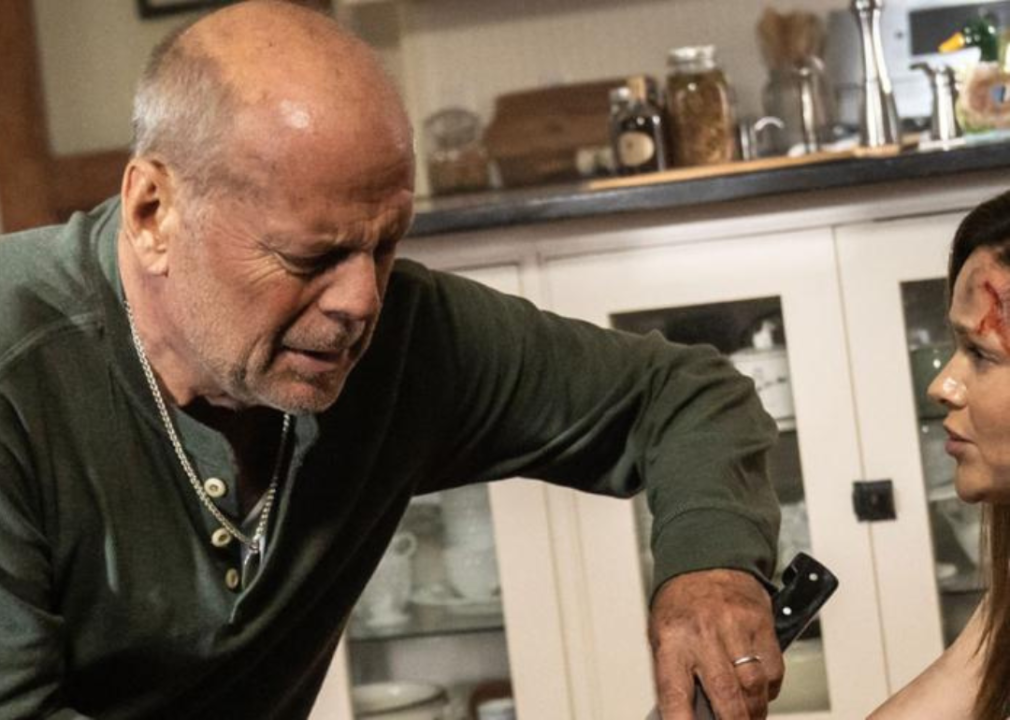 Bruce Willis uses a kitchen knife to cut a woman free.