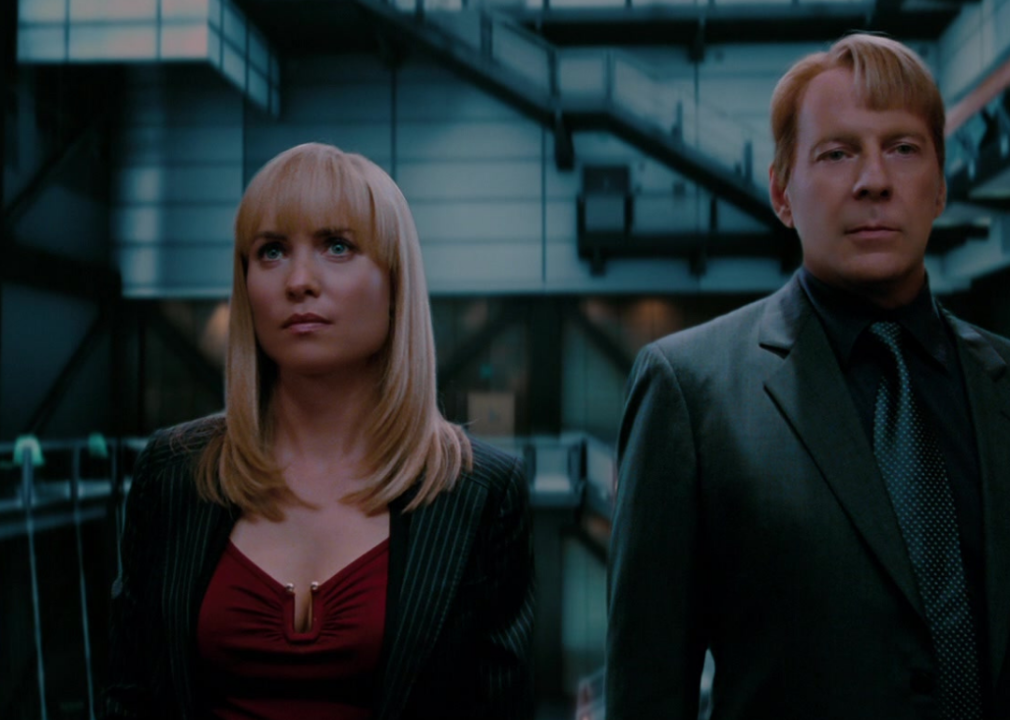 A futuristic man and woman stand facing forward looking serious.