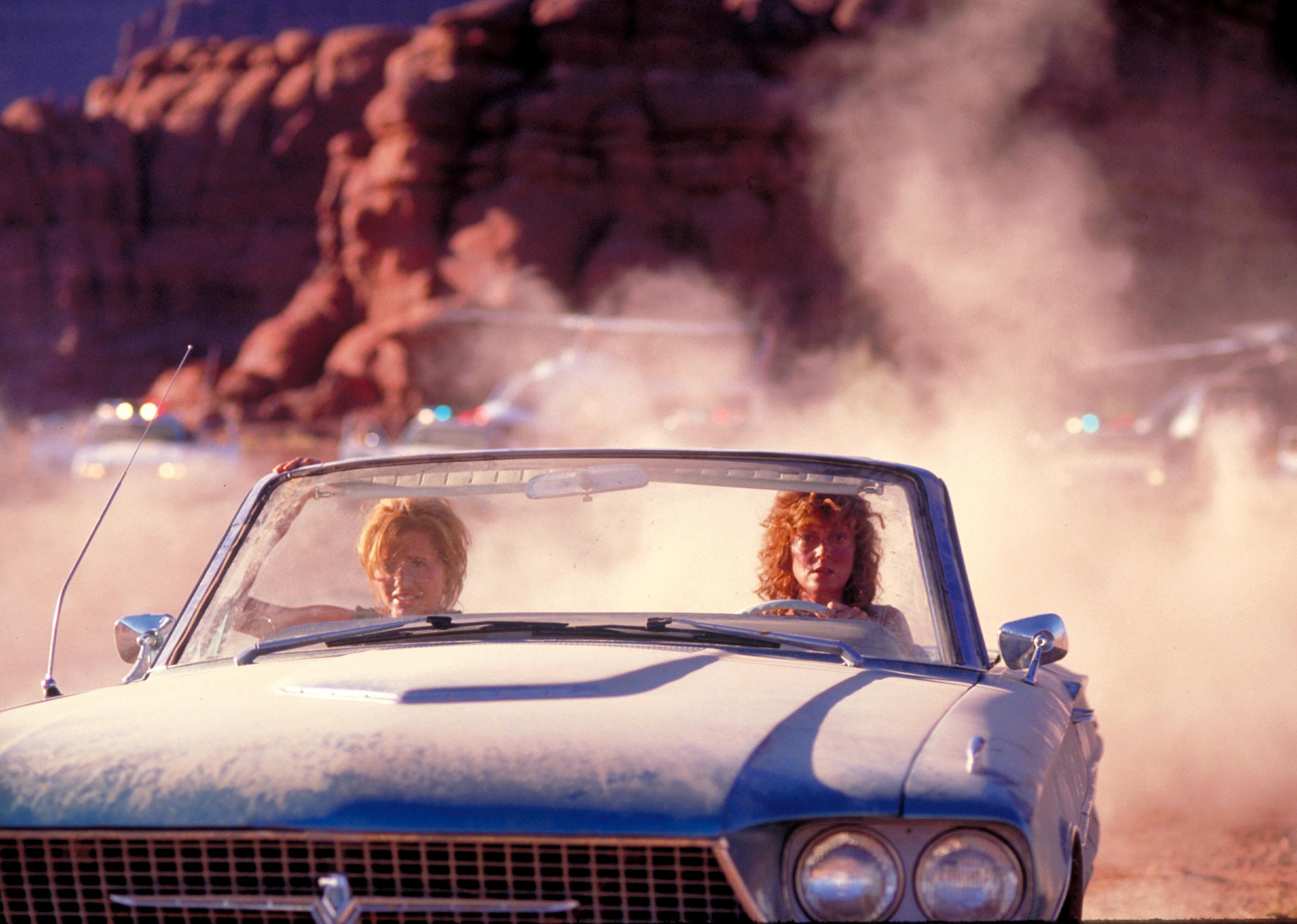 Geena Davis and Susan Sarandon in a classic blue convertible.