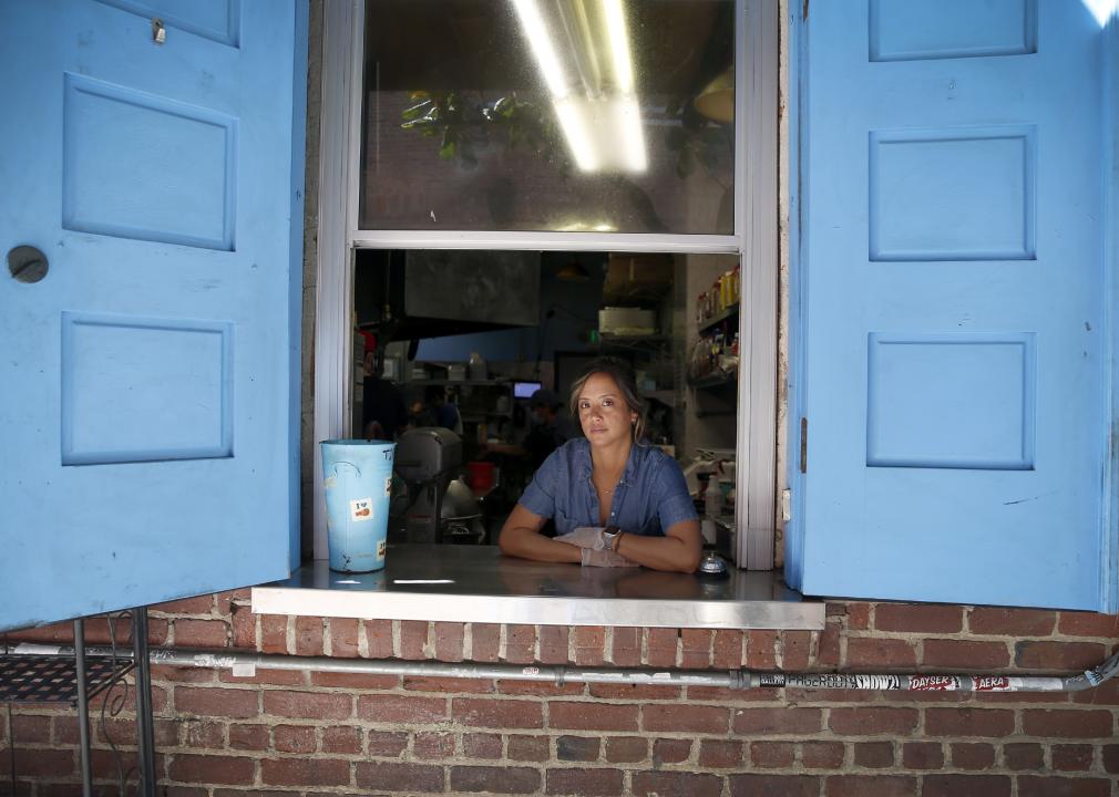 A woman at the takeout windows of her restaurant in San Francisco.