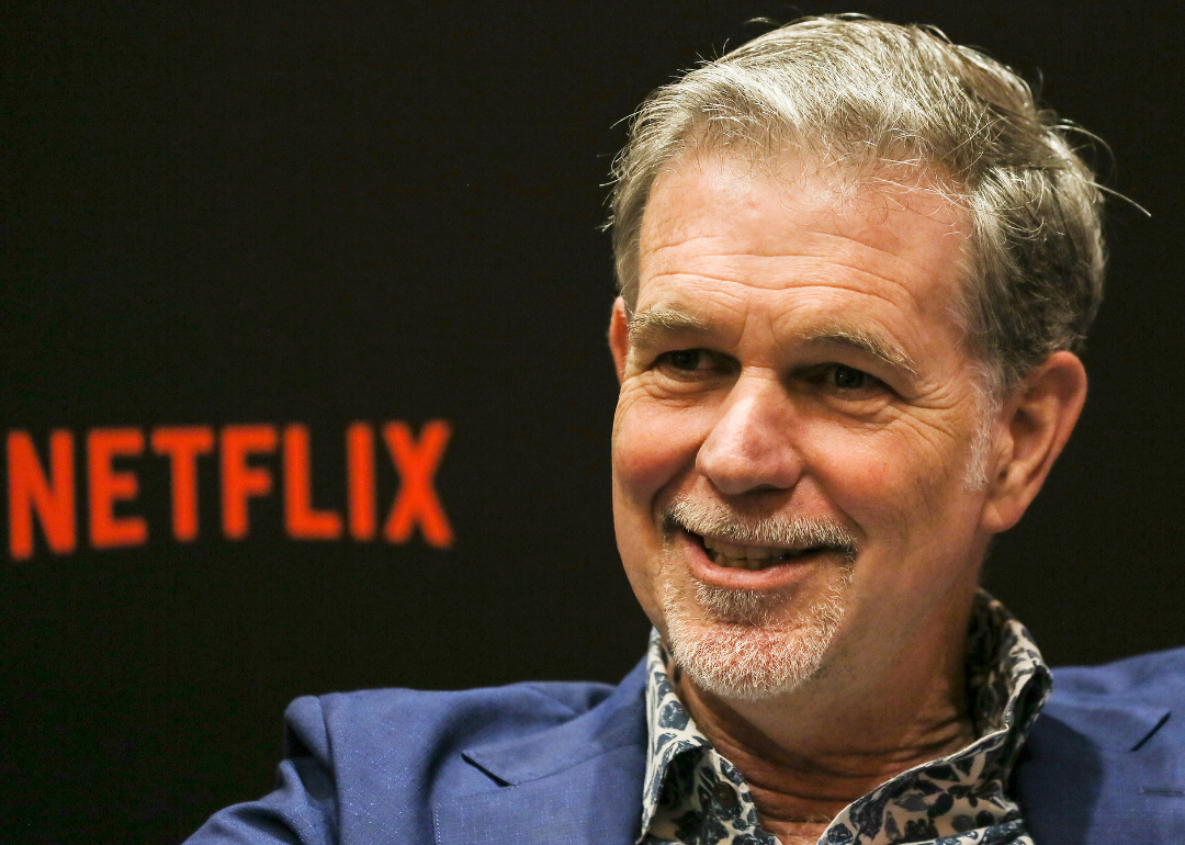Reed Hastings in front of a Netflix background.