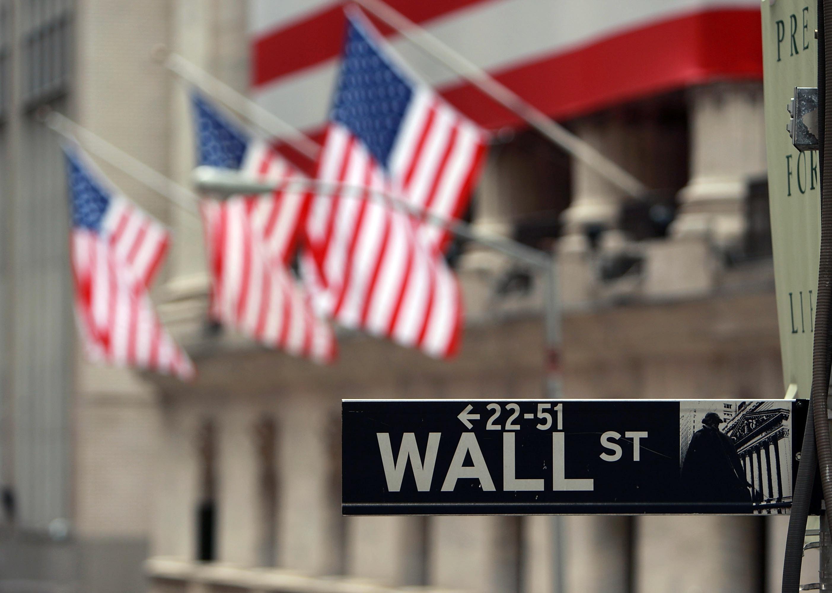 Wall Street sign and American flags.