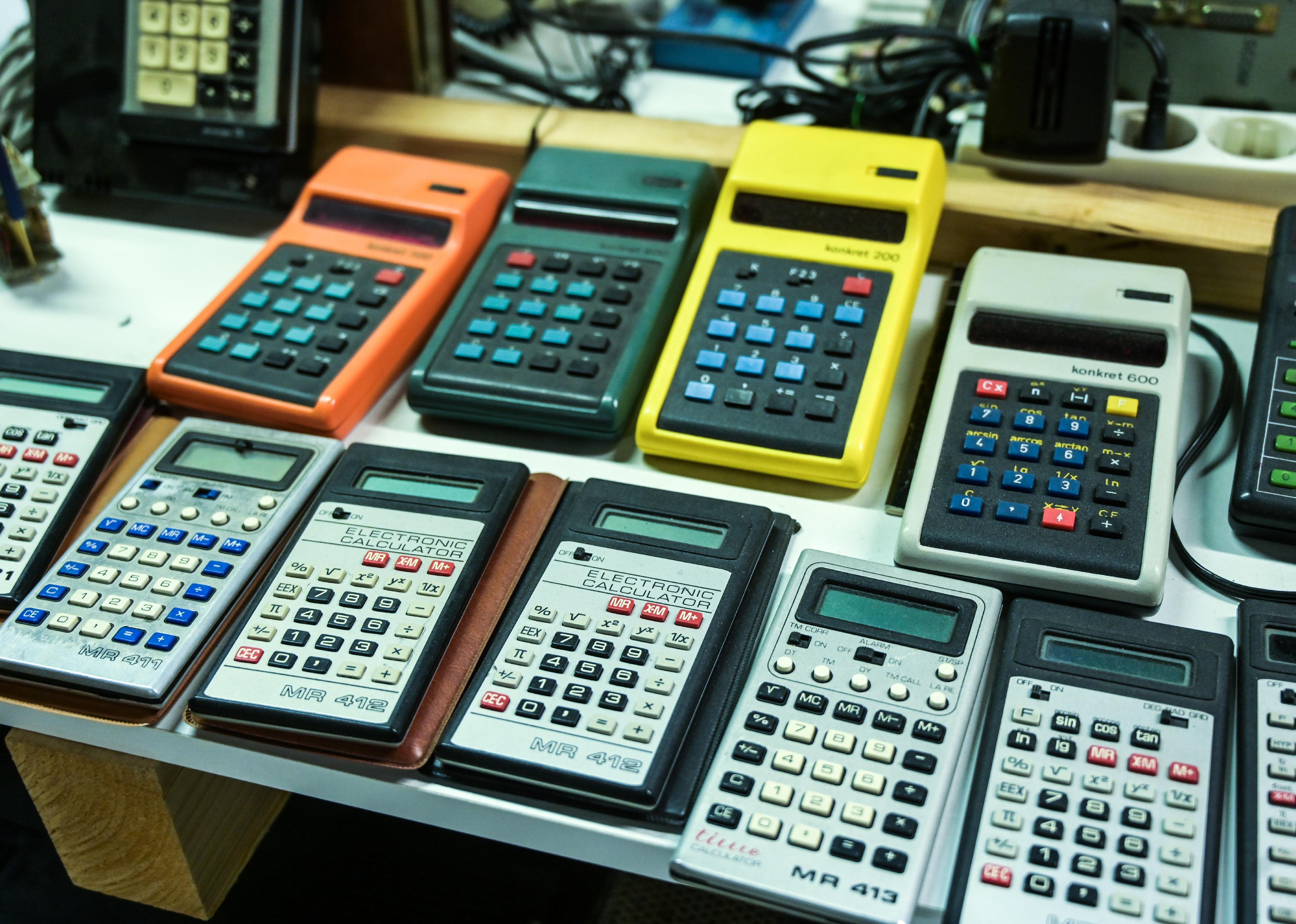 A collection of vintage pocket calculators from different generations.
