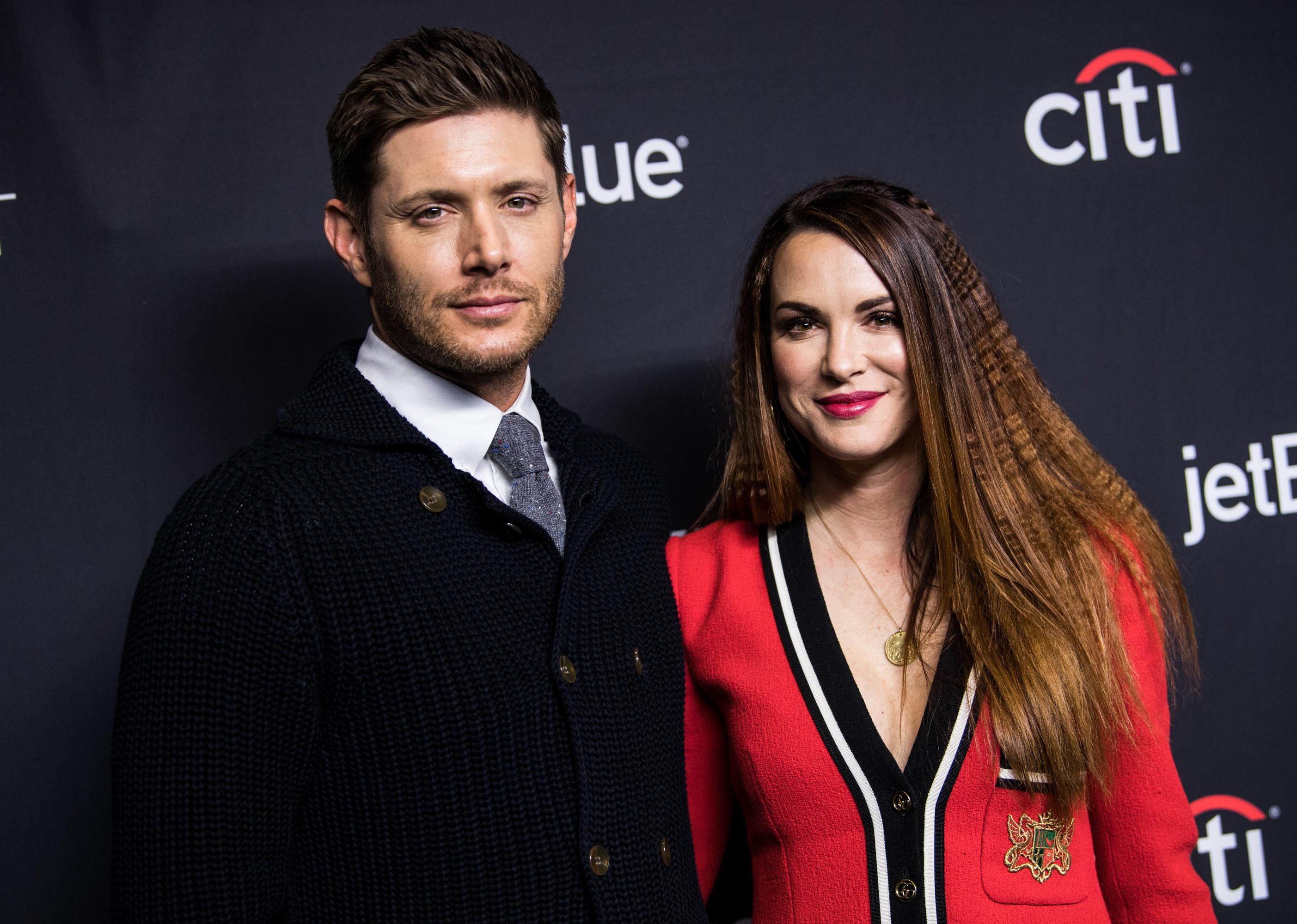 Jensen and Danneel Ackles posing on red carpet.