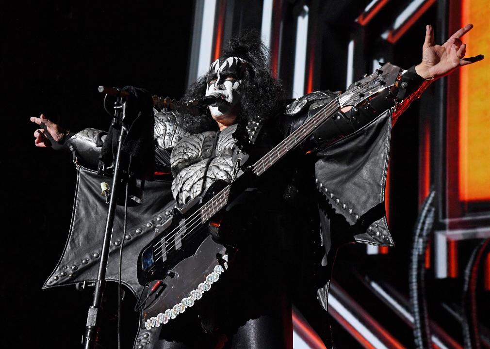 Gene Simmons performs as a member of the band Kiss in full black-and-white makeup and costume.
