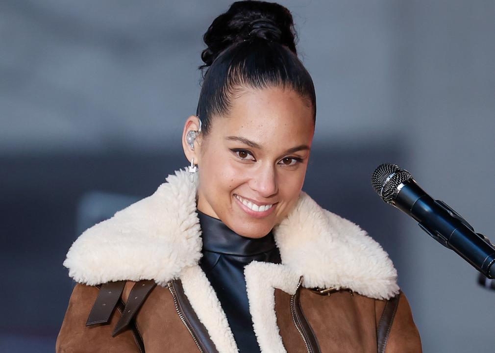 Alicia Keys in a brown bomber jacket.