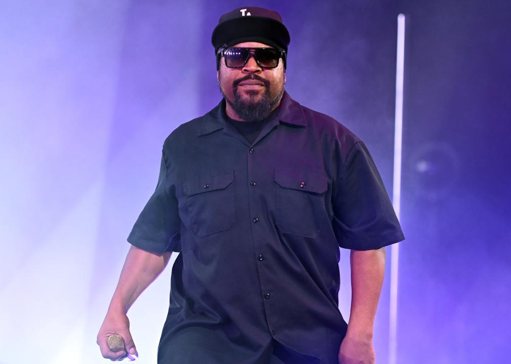 Ice Cube on stage in sunglasses and a black shirt.