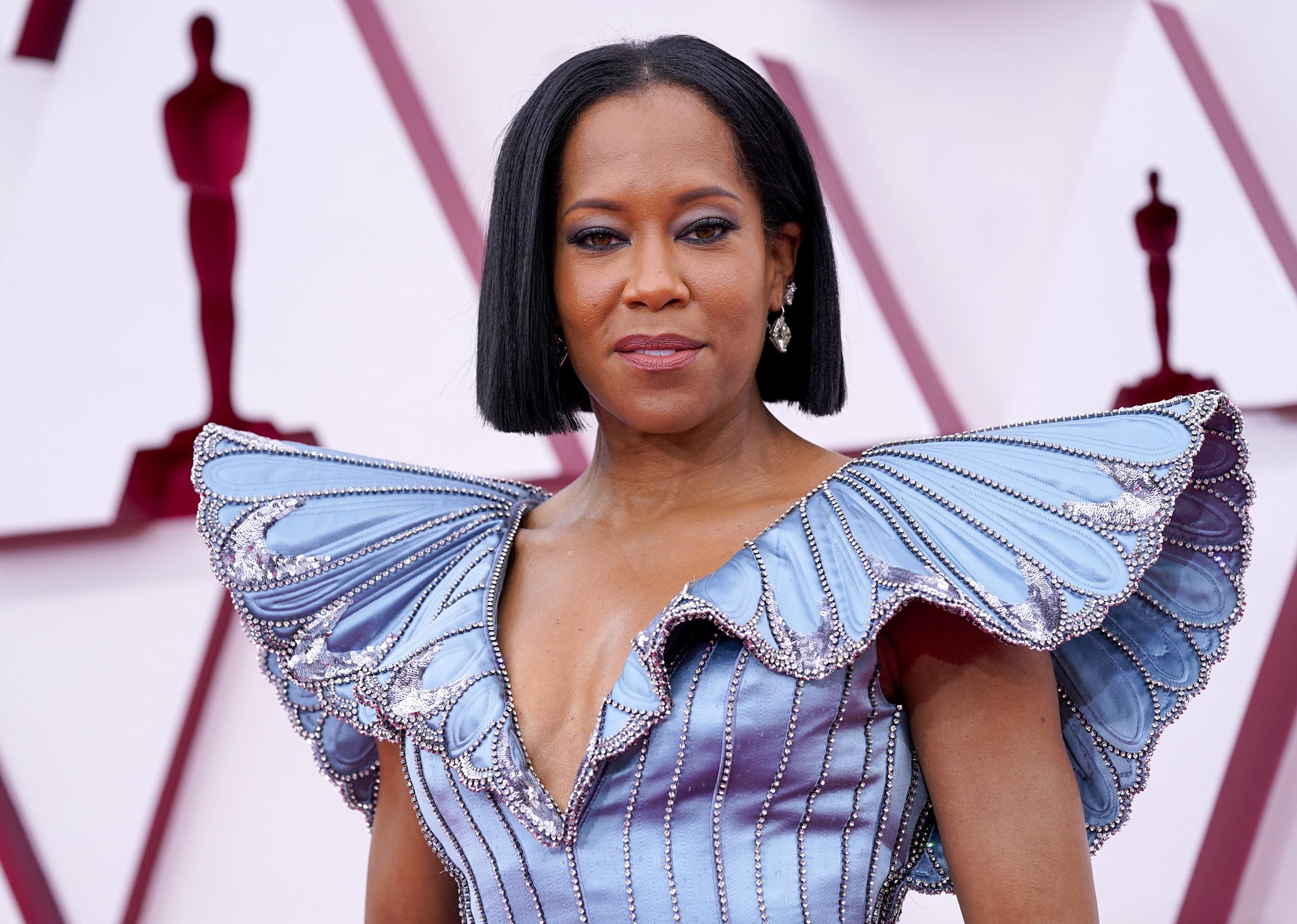Regina King in a blue sparkly butterfly gown.