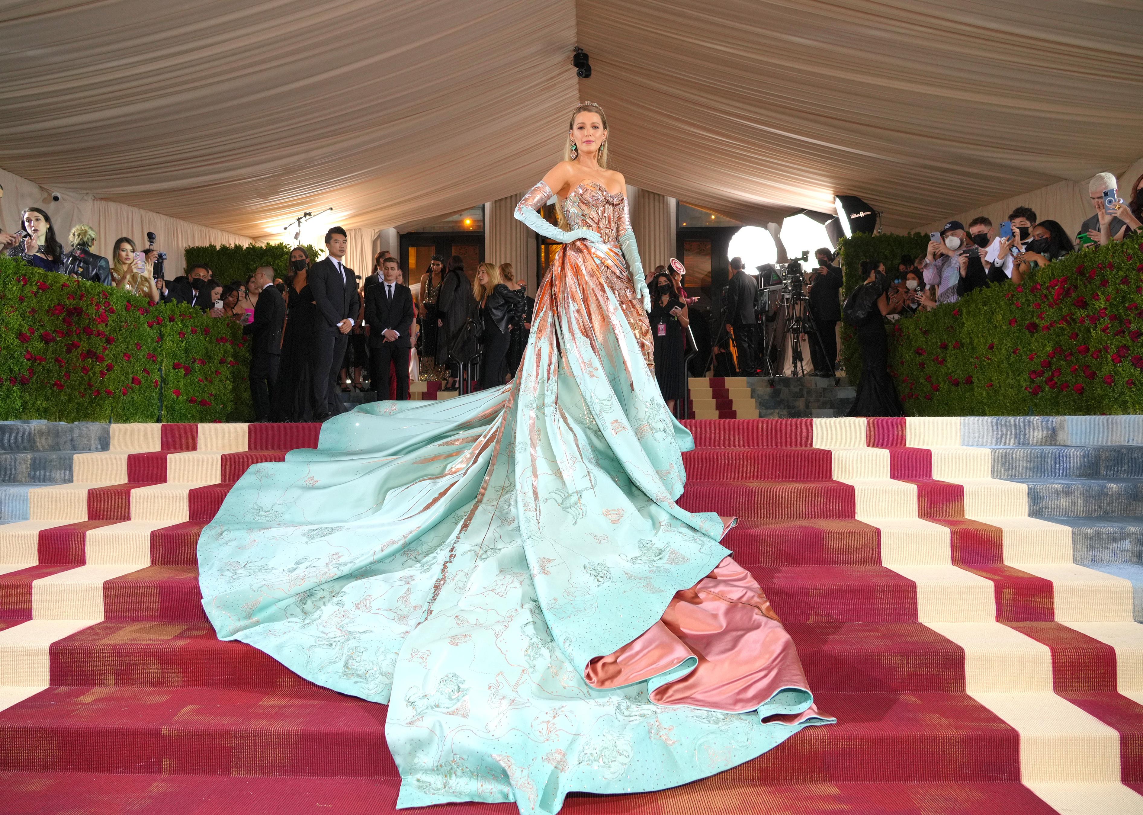 Blake Lively in a pale blue-and-peach long gown on the red carpet.
