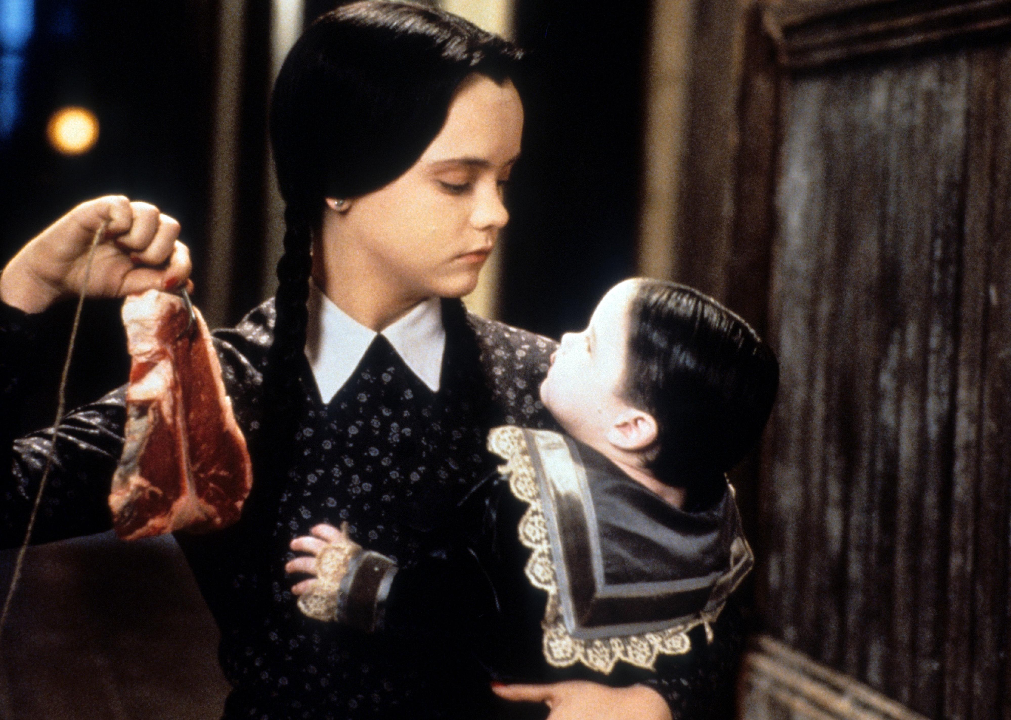 Christina Ricci dangling meat in a scene from 'Addams Family Values'.
