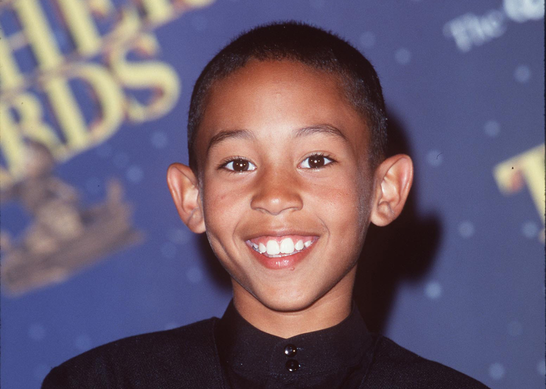 Young Tahj Mowry in a black suit.