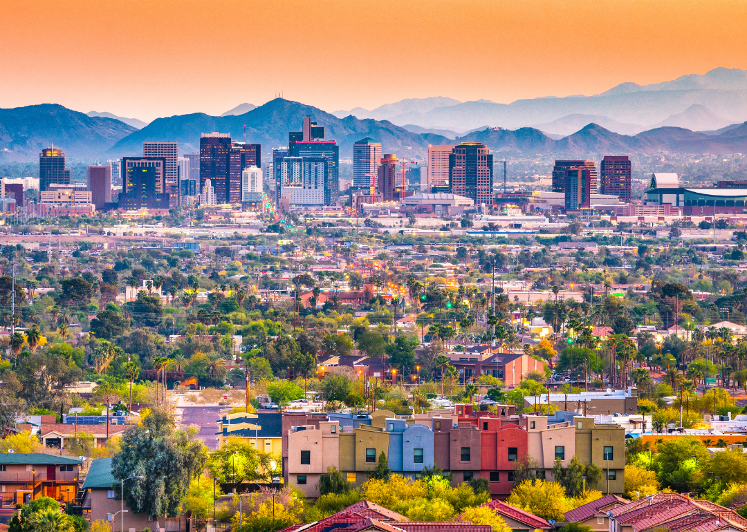 Colorful apartments and homes with the Phoenix skyline in the distance.