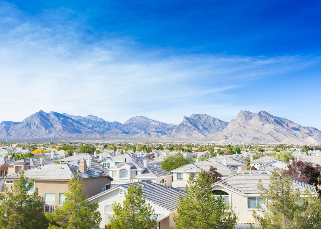 An aerial view of homes in Las Vegas with mountains in the background.