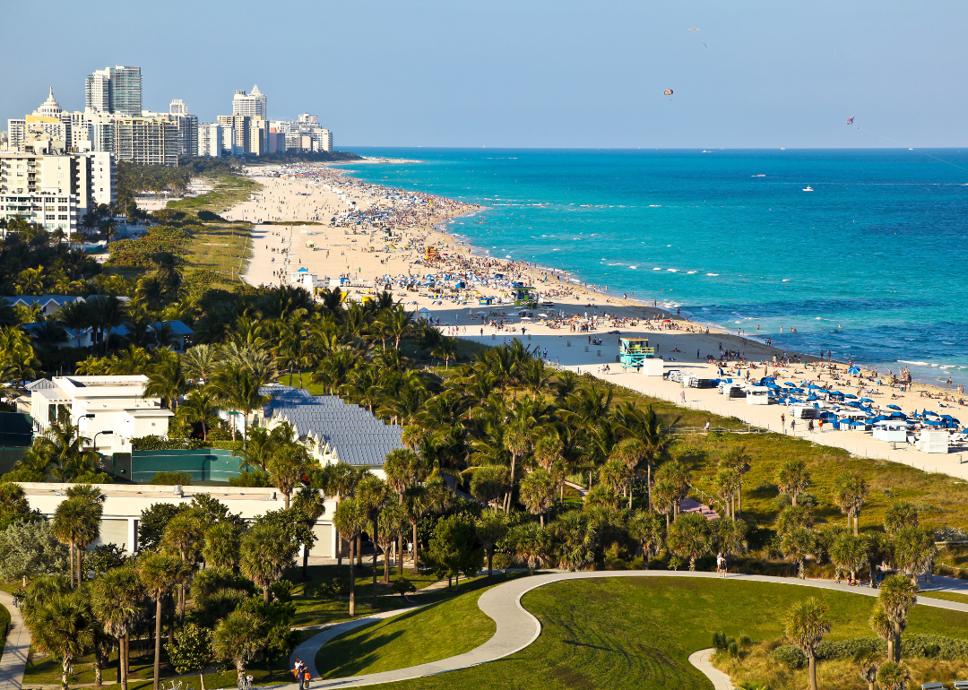 Homes and buildings on a white sand beach.