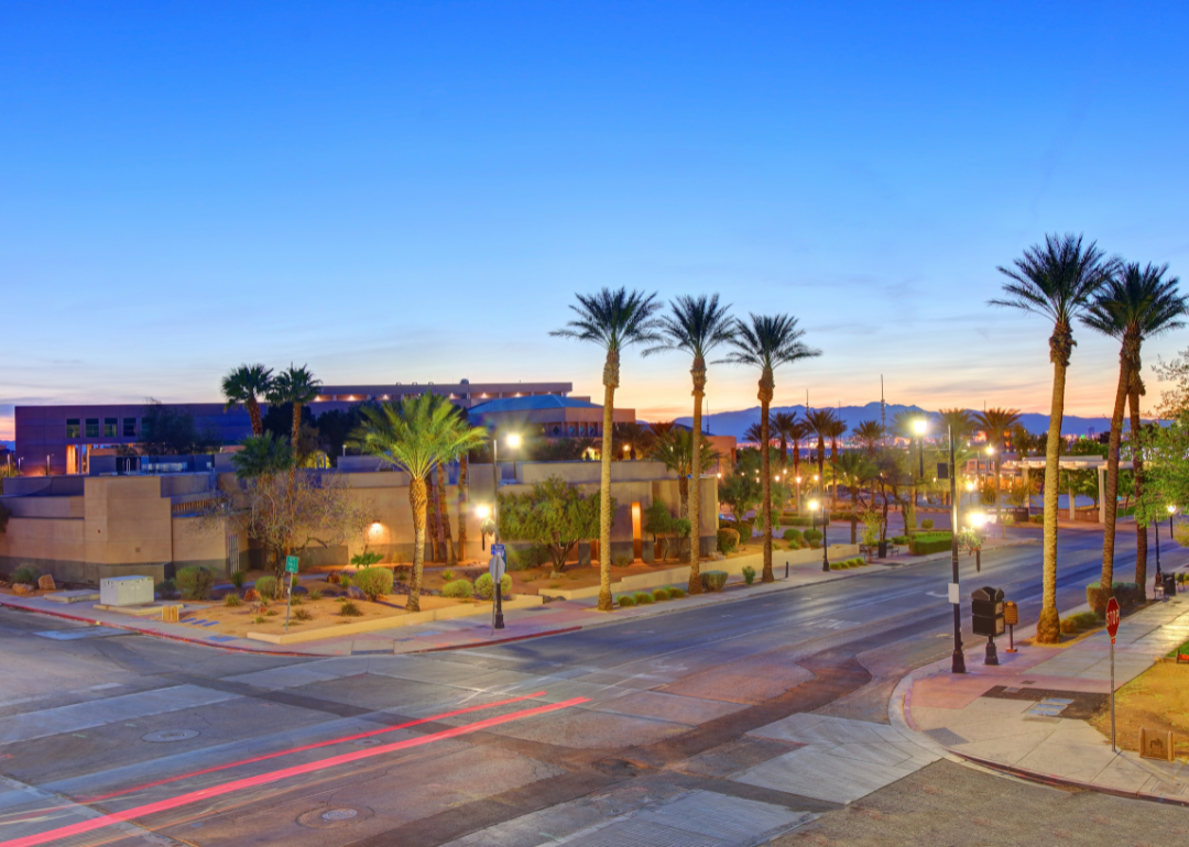 Quiet streets lined with palm trees at twilight.